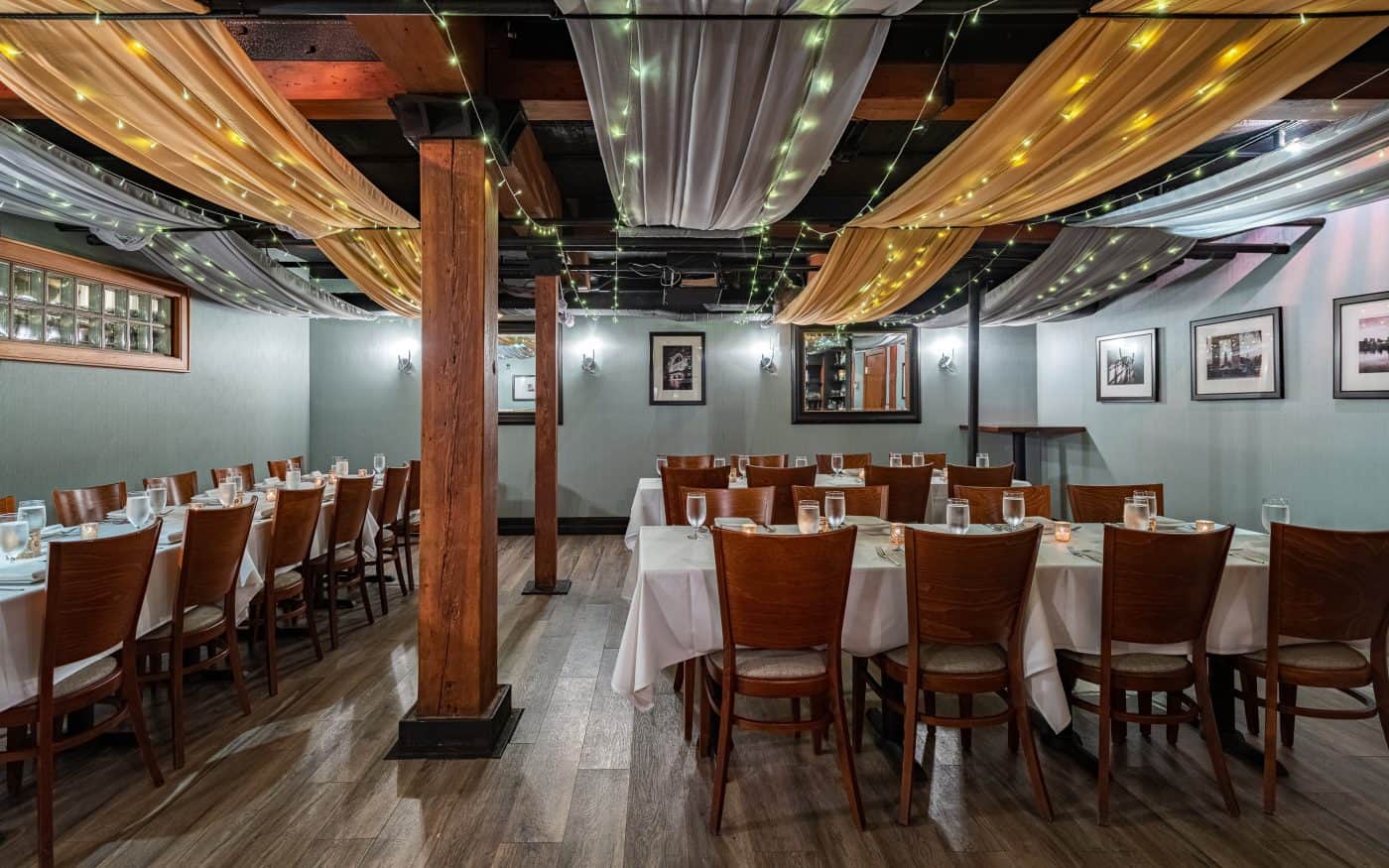 Cozy private dining room with twinkle lights and elegant table settings in Providence