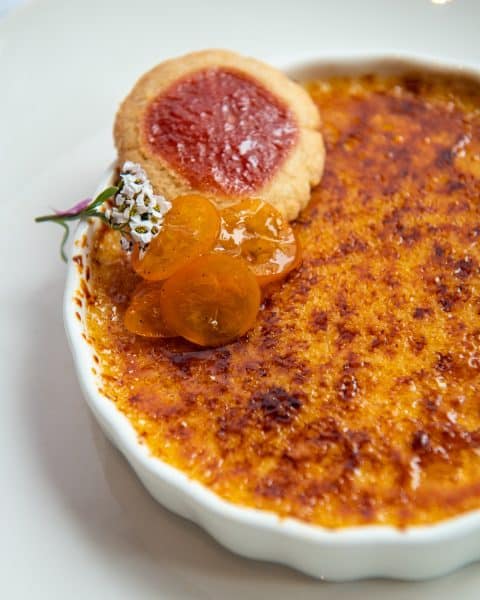 Elegant creme brulee dessert plated at Gracie’s fine dining Providence
